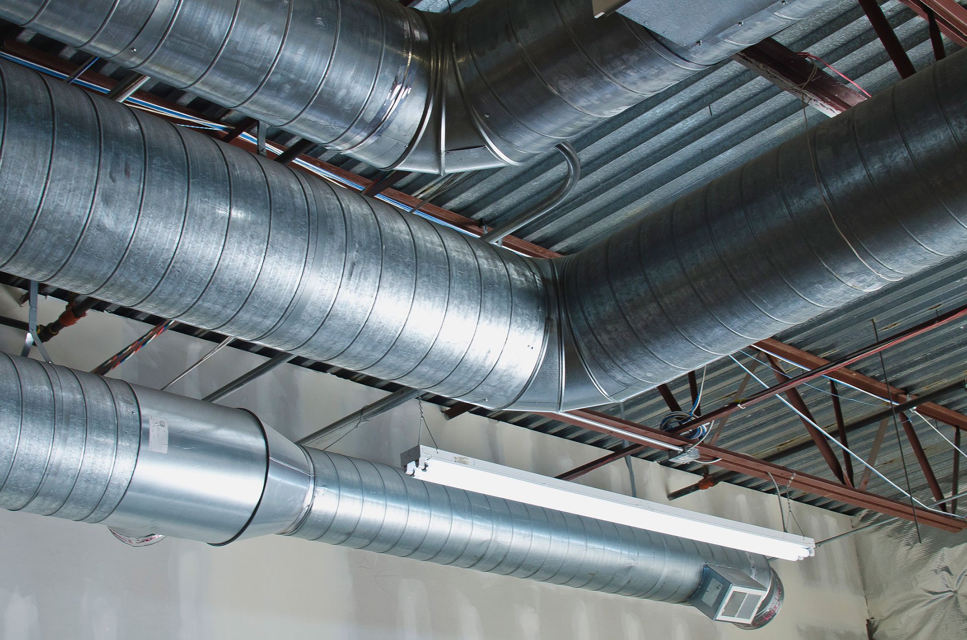 Commercial HVAC ductwork running across the ceiling of a Wichita-area business facility