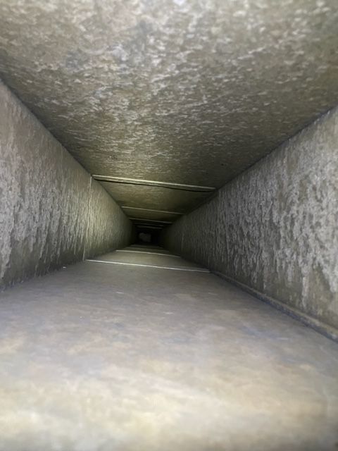 Same hospital HVAC air duct interior after Vortex professional cleaning, restored to clean bare metal