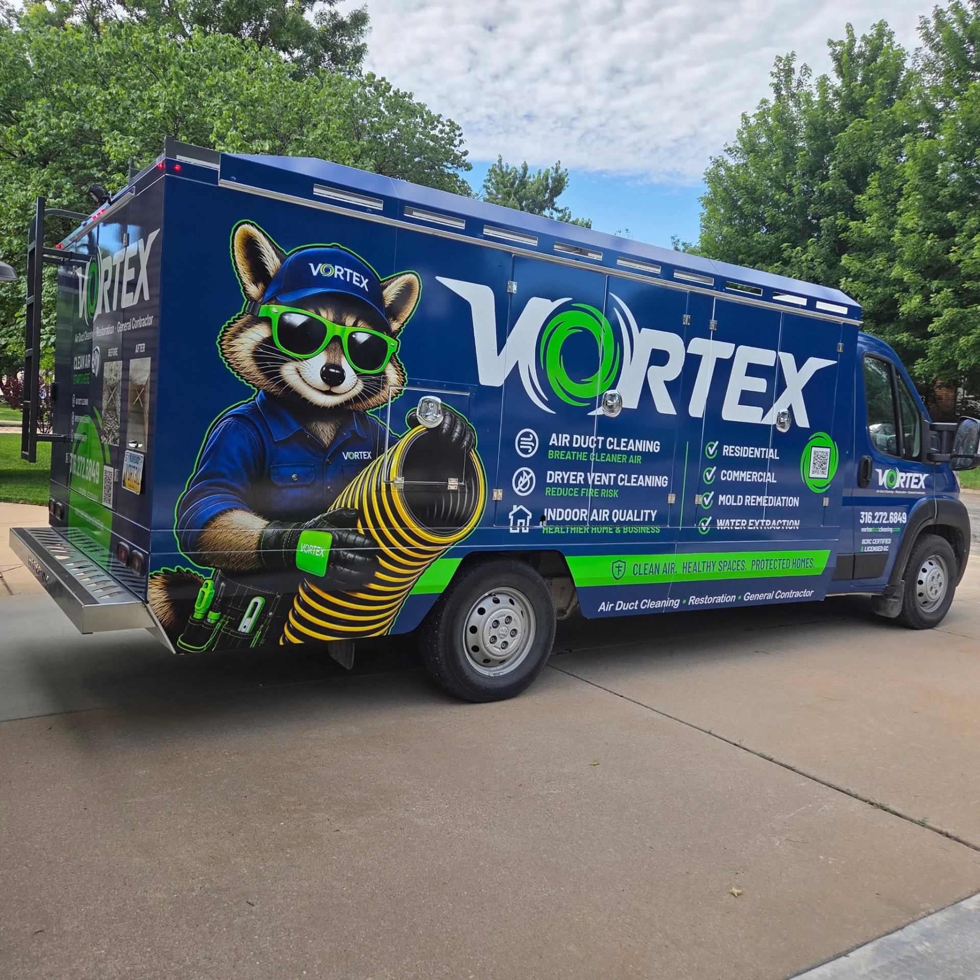 Truck-mounted air duct cleaning vacuum connected to a Wichita, Kansas home HVAC system