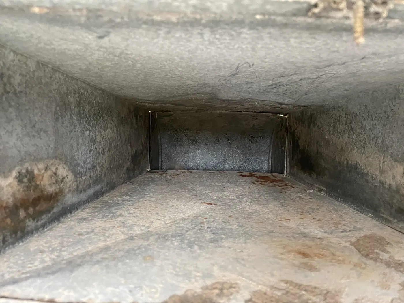 Same Wichita home air duct interior after Vortex cleaning, restored to clean bare metal
